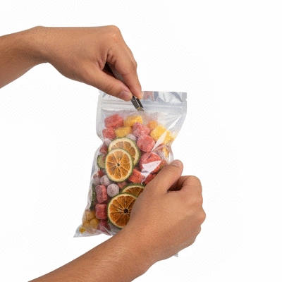 Person sealing a Mylar bag filled with freeze-dried treats
